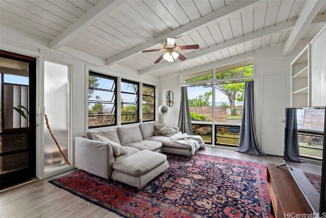 living room featuring lofted ceiling with beams, hardwood / wood-style flooring, and ceiling fan