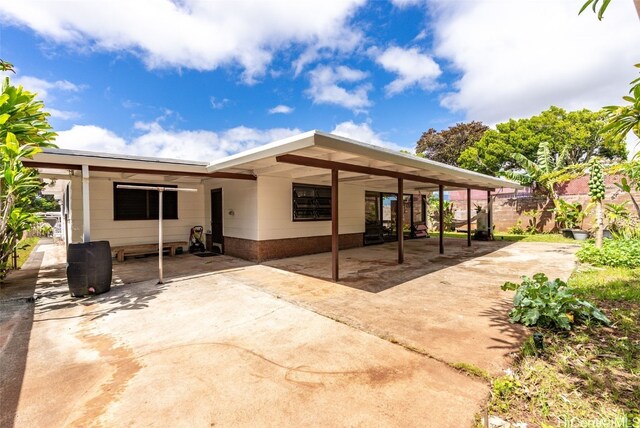 back of property with a carport