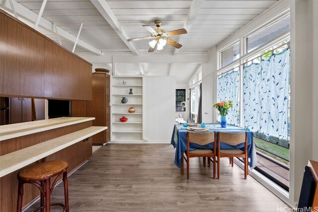 dining room featuring ceiling fan, a healthy amount of sunlight, and dark hardwood / wood-style flooring