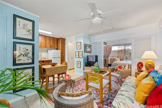 tiled living room featuring ceiling fan