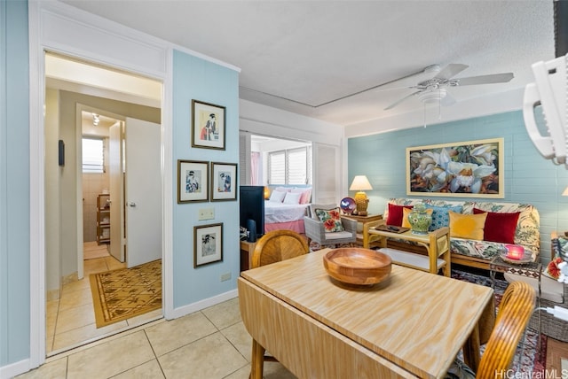 tiled dining room with ceiling fan