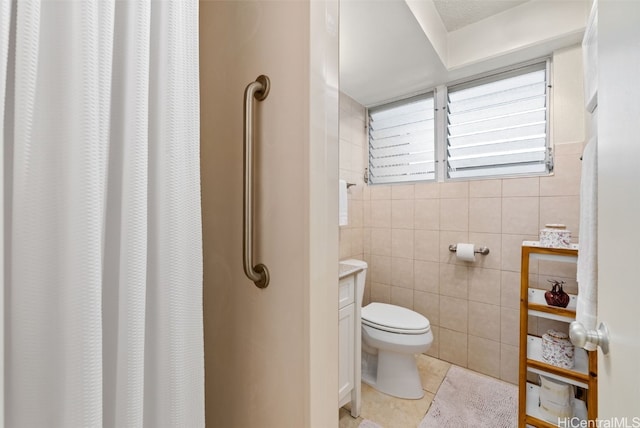 bathroom featuring tile walls, curtained shower, toilet, and tile patterned flooring