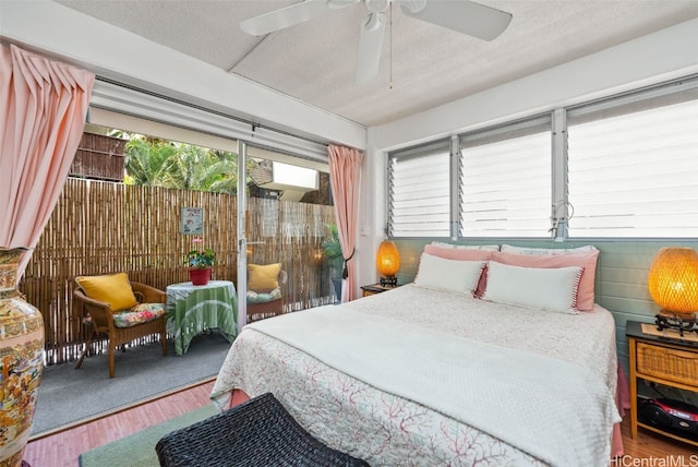 bedroom with hardwood / wood-style flooring, a textured ceiling, and ceiling fan