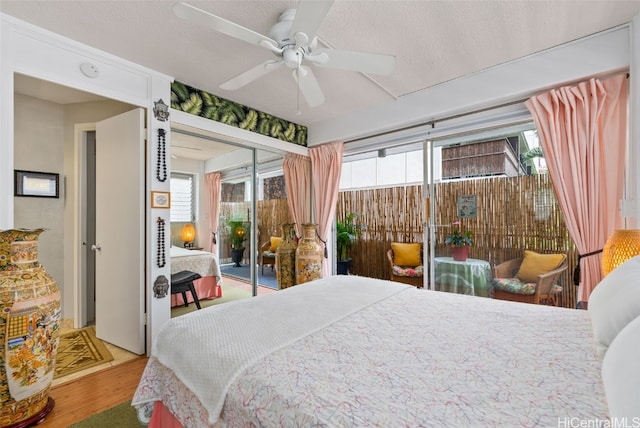 bedroom featuring ceiling fan, hardwood / wood-style flooring, a textured ceiling, and access to exterior