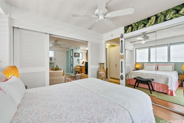 bedroom featuring a closet, ceiling fan, wood-type flooring, and a textured ceiling