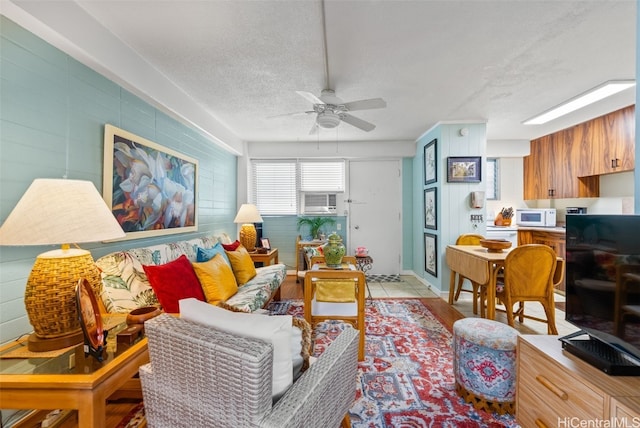 living room with a textured ceiling and ceiling fan