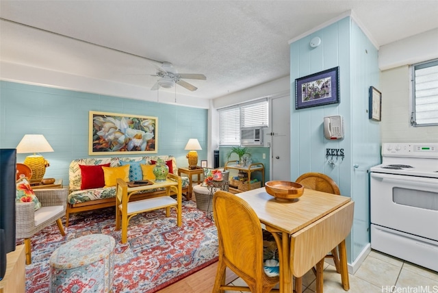 tiled dining room featuring a textured ceiling and ceiling fan