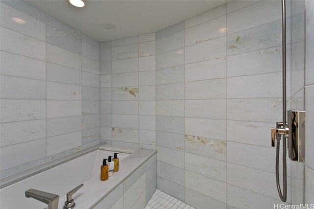 bathroom featuring shower with separate bathtub