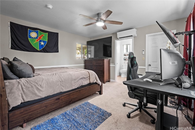 bedroom with ceiling fan, ensuite bathroom, a wall unit AC, light carpet, and baseboards