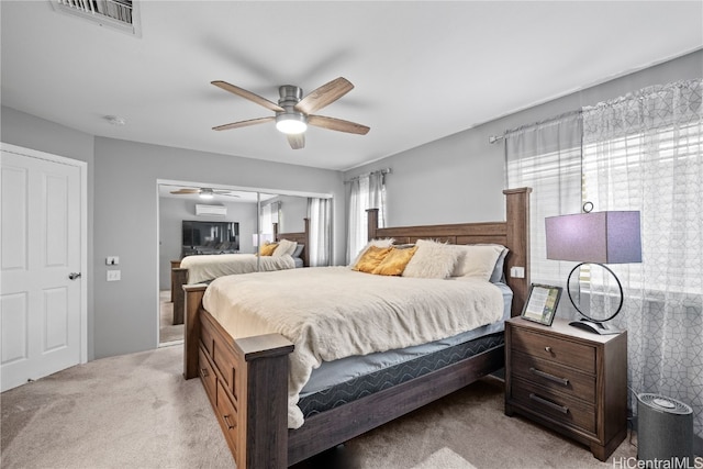 bedroom with light carpet, visible vents, and a ceiling fan