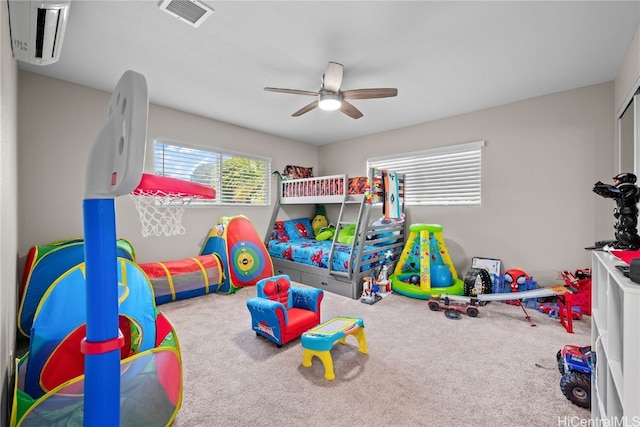 rec room featuring carpet flooring, visible vents, and a ceiling fan