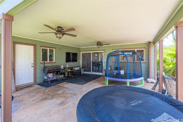 view of patio / terrace with ceiling fan and a trampoline