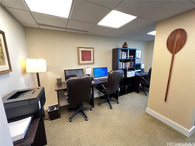 carpeted office space with a drop ceiling