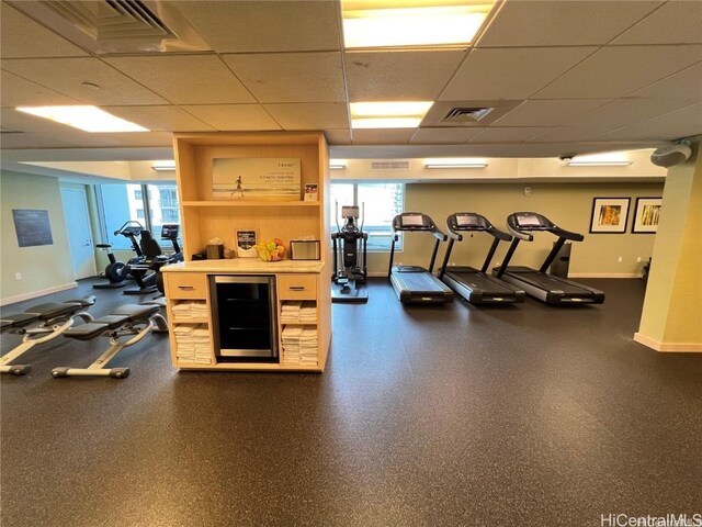 exercise room featuring a paneled ceiling