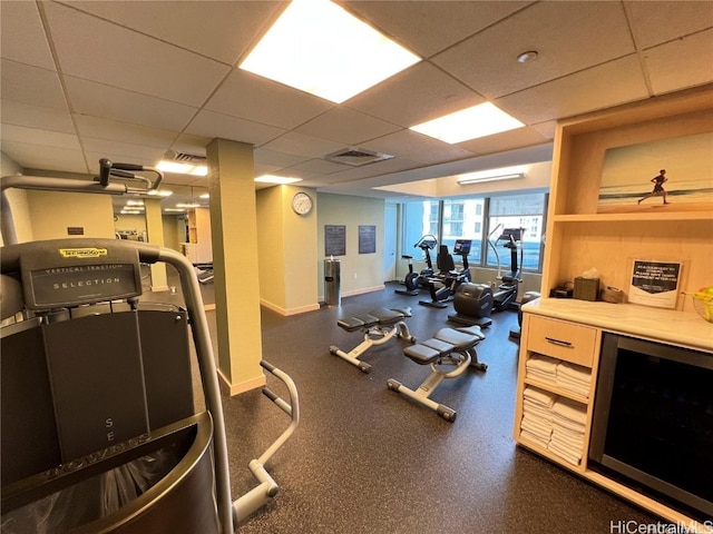 gym with a paneled ceiling