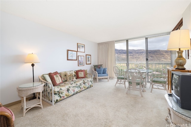 carpeted living room featuring expansive windows