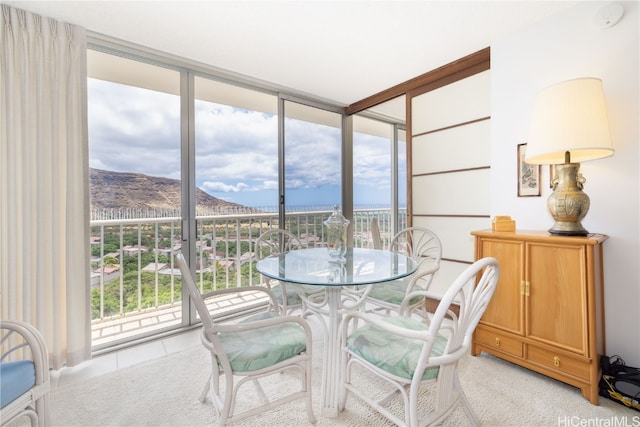 sunroom / solarium with a mountain view and a healthy amount of sunlight