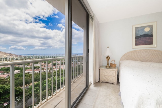 bedroom with a water view, light tile patterned flooring, a wall of windows, and access to exterior