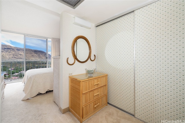 bedroom featuring a mountain view and light colored carpet