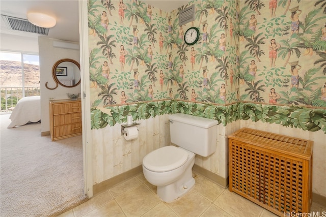 bathroom with toilet and tile patterned floors