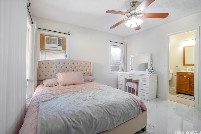 bedroom featuring a textured ceiling, connected bathroom, and ceiling fan