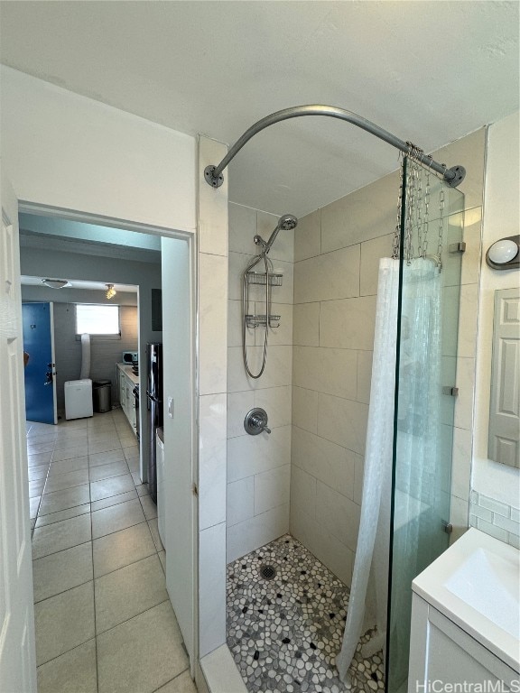 bathroom with a shower with curtain, vanity, and tile patterned flooring