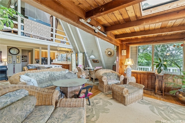 interior space with vaulted ceiling with skylight and wood ceiling