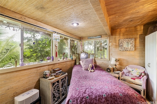 bedroom with wood ceiling and wooden walls