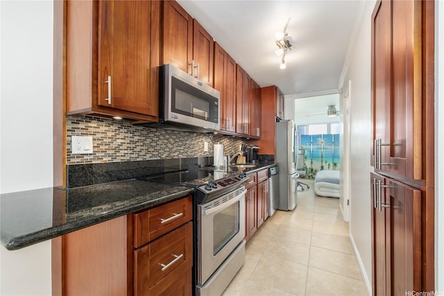 425 Ena Rd Unit 1202A, Honolulu, HI 96815 - kitchen with backsplash, a sink, dark stone counters, stainless steel appliances, and light tile patterned flooring