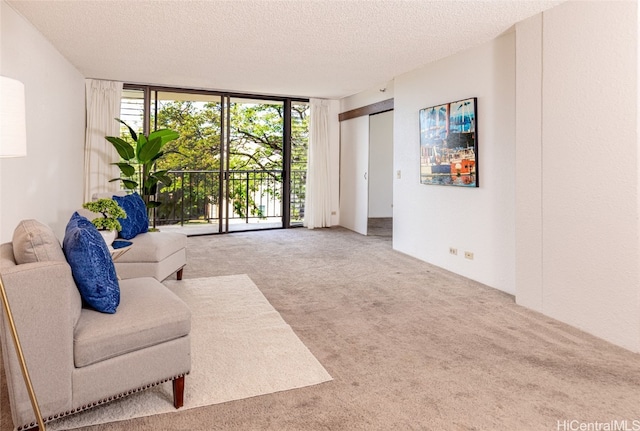 living room with a textured ceiling, carpet, and floor to ceiling windows