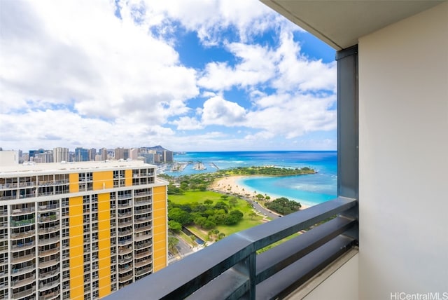 balcony featuring a water view and a view of the beach