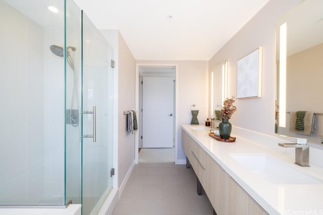 bathroom featuring vanity, a shower with shower door, and tile patterned flooring