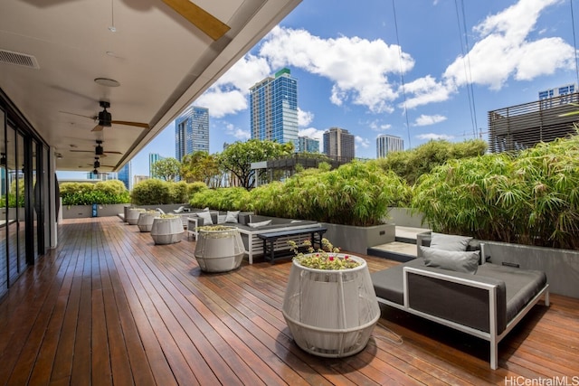 deck featuring an outdoor living space and ceiling fan