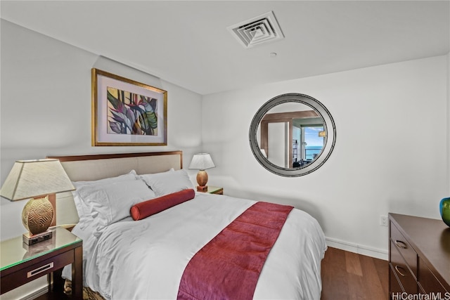 bedroom with dark wood-type flooring