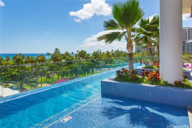 view of pool with a water view