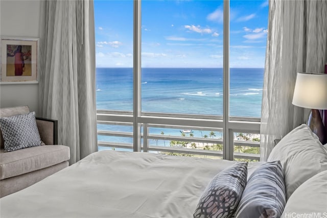 bedroom with a water view and a beach view