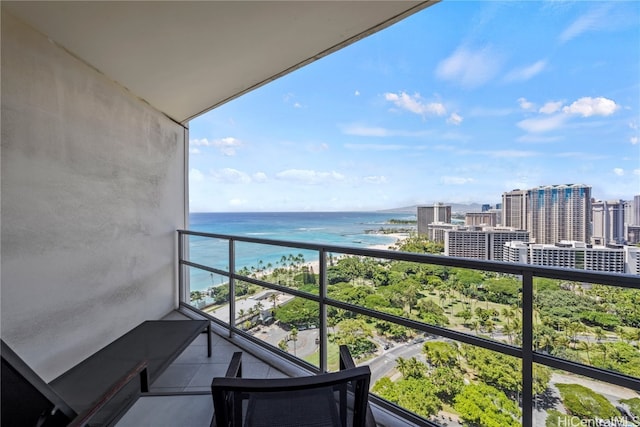 balcony with a water view and a beach view