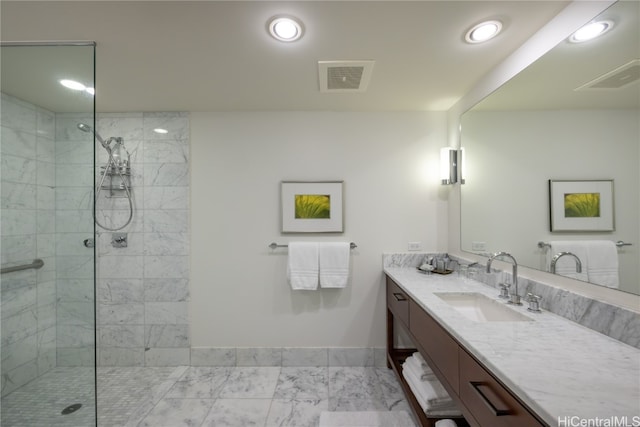 bathroom featuring vanity and tiled shower