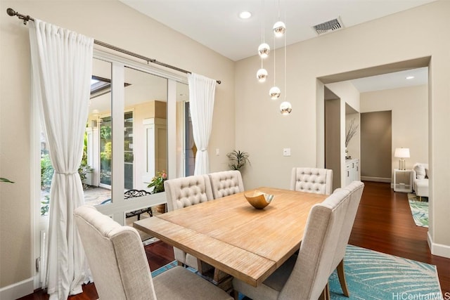 dining space featuring dark wood-type flooring