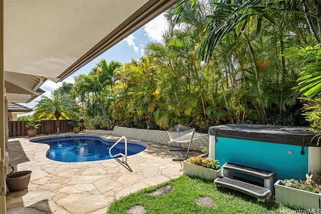 view of pool featuring a patio and a hot tub