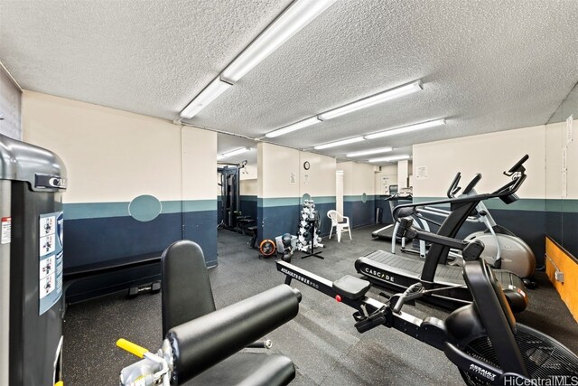 gym featuring a textured ceiling