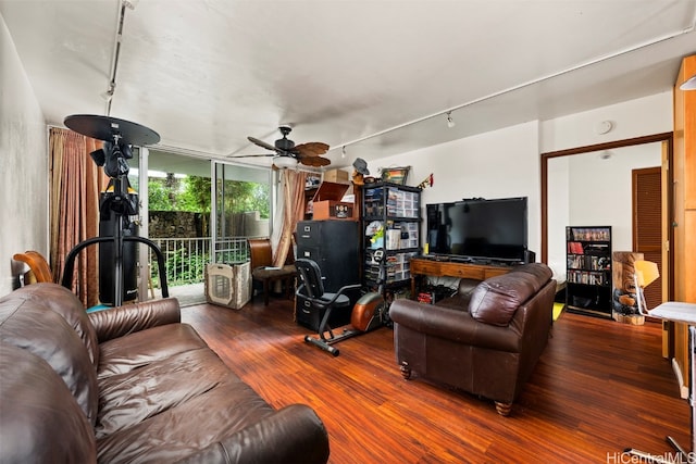 living room featuring dark hardwood / wood-style flooring, expansive windows, ceiling fan, and rail lighting