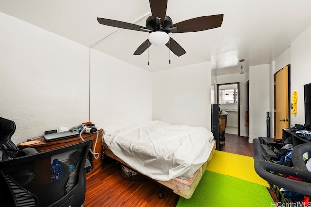 bedroom with dark hardwood / wood-style flooring and ceiling fan