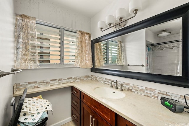 bathroom featuring vanity, tasteful backsplash, and walk in shower