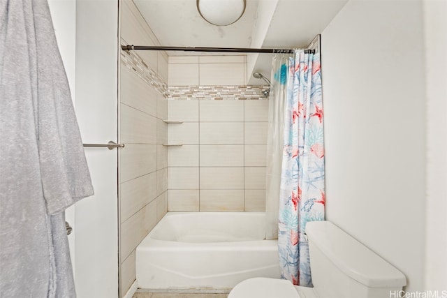 bathroom featuring toilet and shower / bathtub combination with curtain