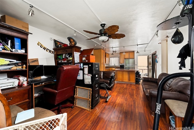 home office featuring sink, dark wood-type flooring, track lighting, and ceiling fan