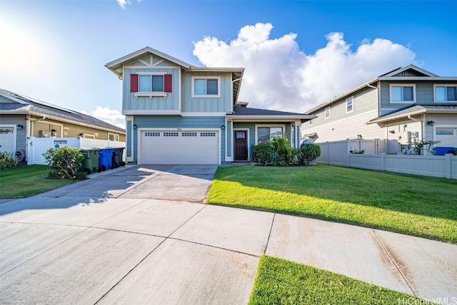 view of front of home with a front yard and a garage