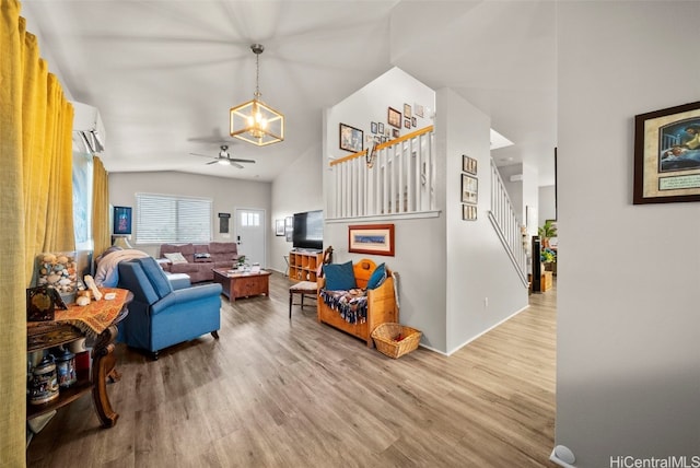 living room featuring ceiling fan, wood-type flooring, lofted ceiling, and a wall unit AC