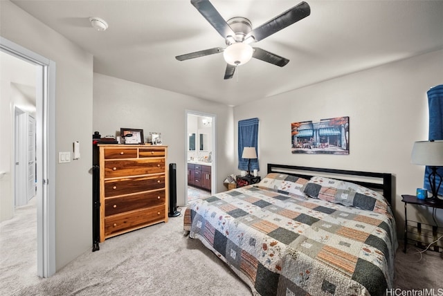 carpeted bedroom featuring connected bathroom and ceiling fan