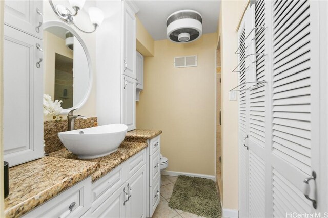 bathroom with tile patterned flooring and vanity